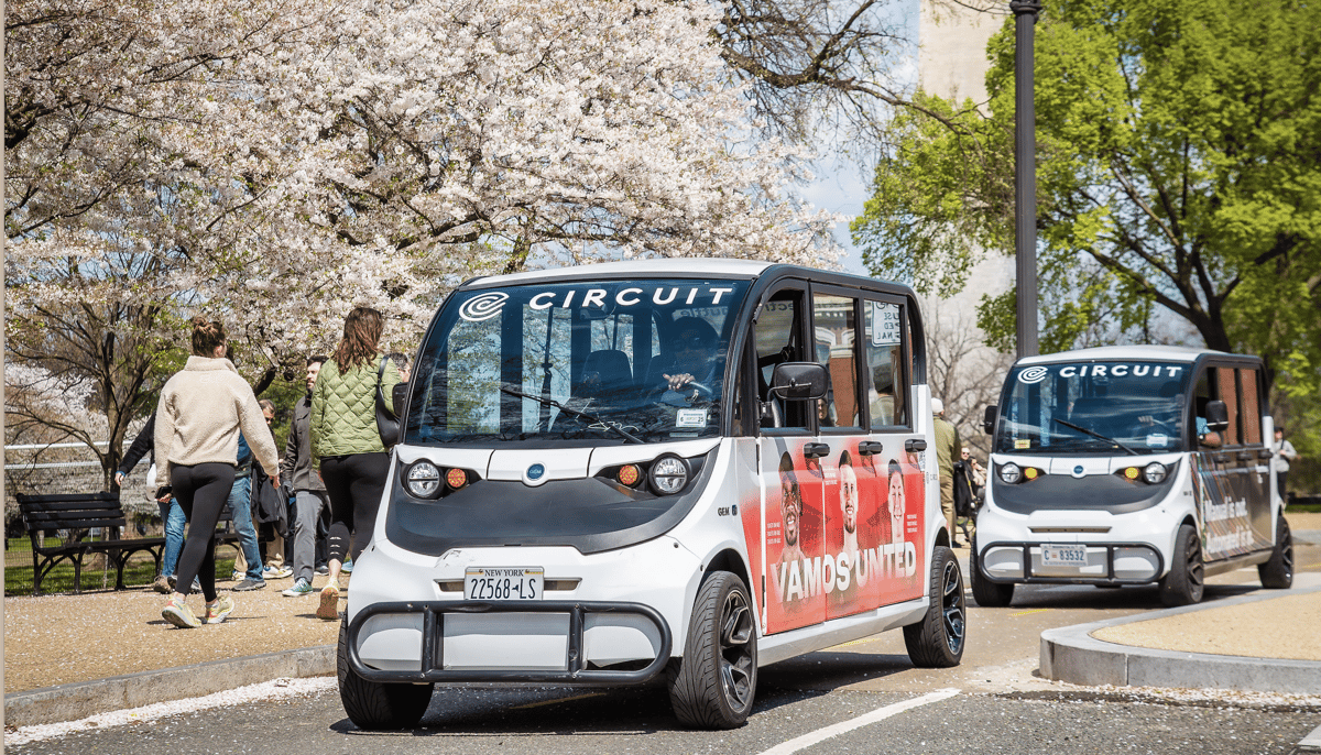 Circuit Shuttle driving in front of DC cherry blossoms
