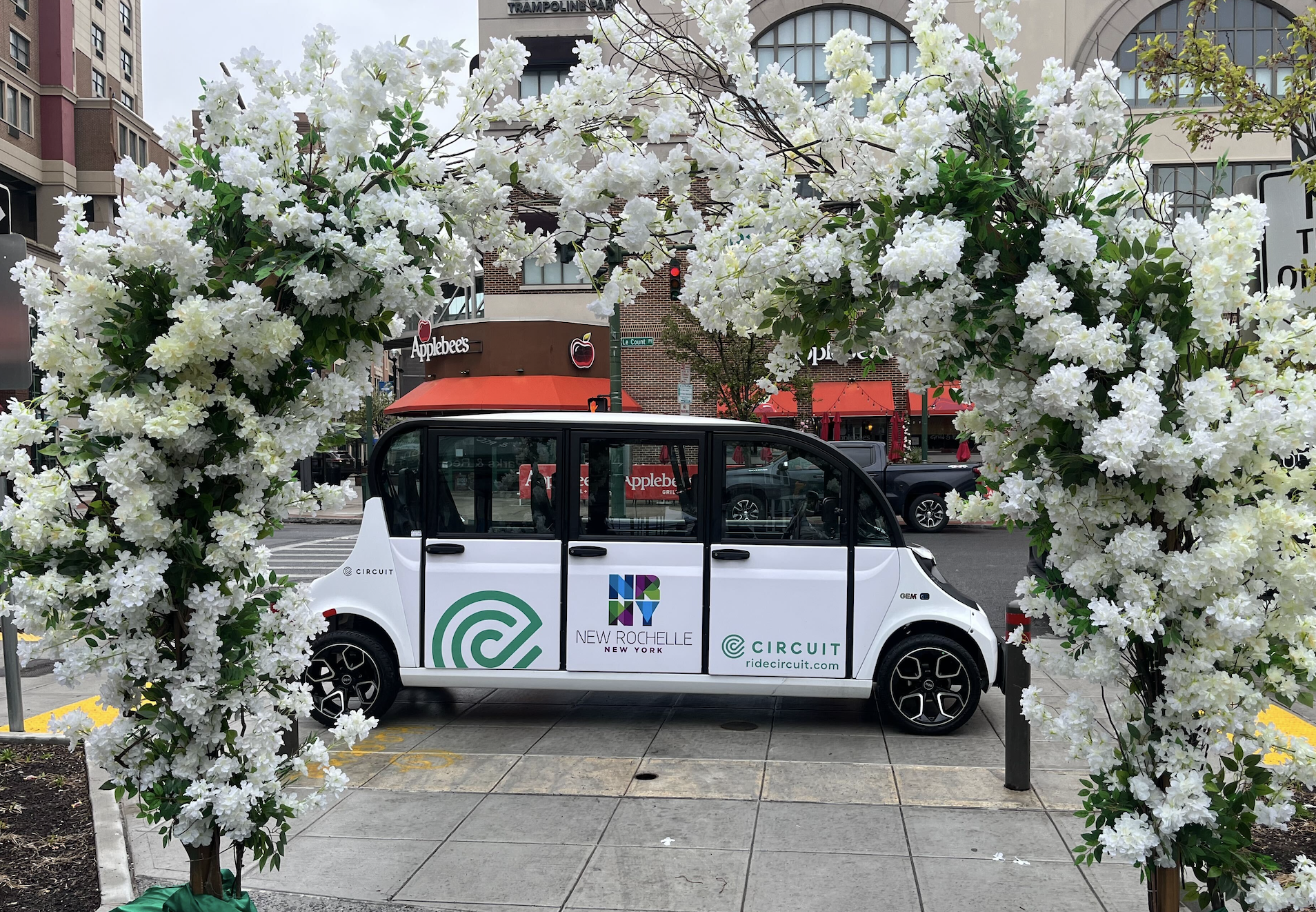 New Rochelle Circuit car framed with a floral arrangement